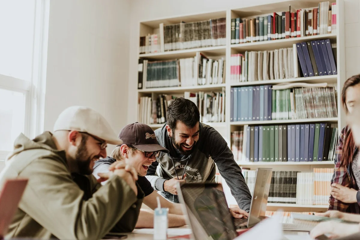 Illustrative photograph of people working together at a laptop